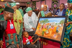 Winner-of-the-paintaing-category-presneting-his-painting-to-the-First-Lady-of-Nigeria-at-the-AGILE-Games-Award-Ceremony-scaled
